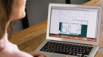 Woman using outdoor planning software on laptop