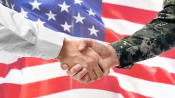 Business man shaking veteran's hand