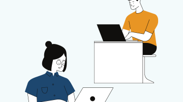 A young man and young woman working on laptops