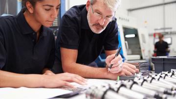 Engineer And Apprentice Planning CNC Machinery Project