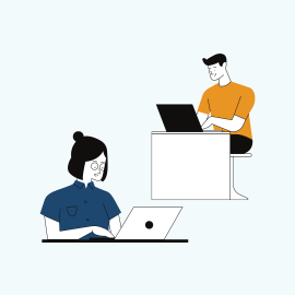 A young man and young woman working on laptops