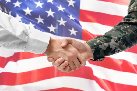 Business man shaking veteran's hand